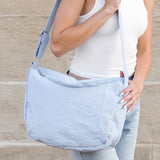 Babe Beachwear Large Nylon Messenger Bag in light blue worn crossbody by woman in white tank top