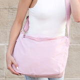 Babe Beachwear Large Nylon Messenger Bag in light pink worn crossbody with adjustable strap