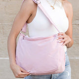 Woman wearing Babe Beachwear Large Nylon Messenger Bag in light pink with adjustable strap