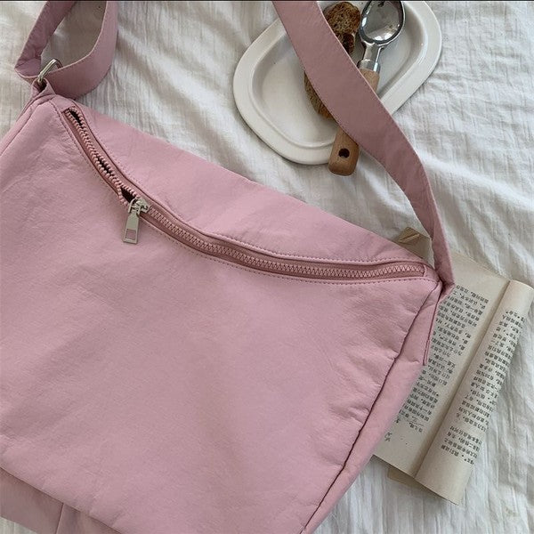 Babe Beachwear Large Nylon Messenger Bag in soft pink with zipper closure on white fabric background