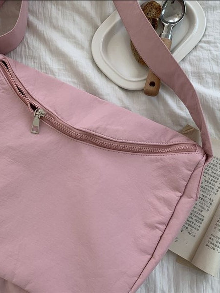 Babe Beachwear Large Nylon Messenger Bag in soft pink with zipper closure on white fabric background