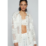 Lightweight Crochet Long white floral crochet top by Trendsi worn by model with matching white outfit