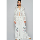 Trendsi lightweight crochet long white top with intricate open knit and floral detail worn by model