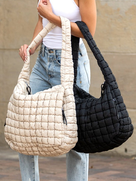 Lightweight Large Quilted Puffer Shoulder Bag in beige and black carried by model wearing white top and jeans