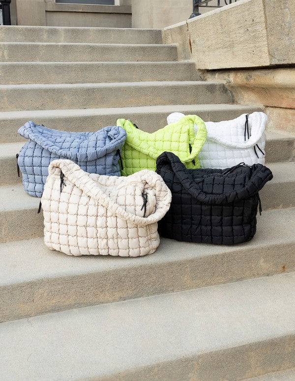 Lightweight Large Quilted Puffer Shoulder Bag in multiple colors from Babe Beachwear displayed on steps