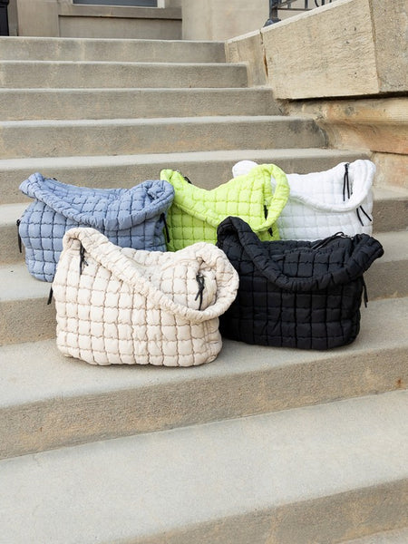 Lightweight Large Quilted Puffer Shoulder Bag in multiple colors from Babe Beachwear displayed on steps