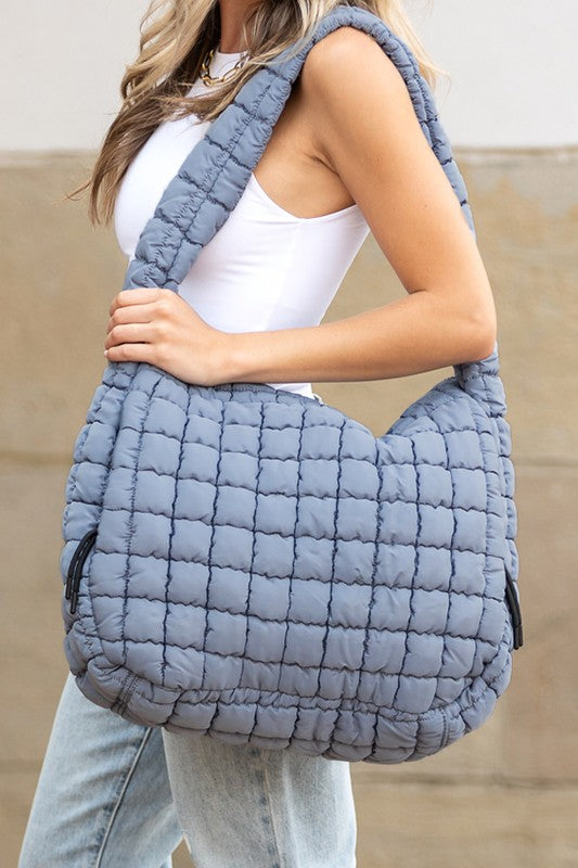 Lightweight Large Quilted Puffer Shoulder Bag in gray worn by woman with white tank top and jeans