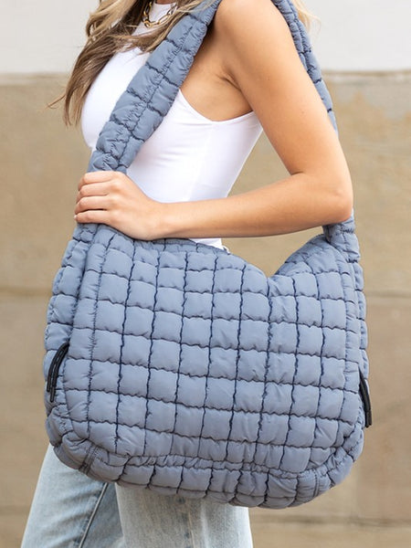Lightweight Large Quilted Puffer Shoulder Bag in gray worn by woman with white tank top and jeans