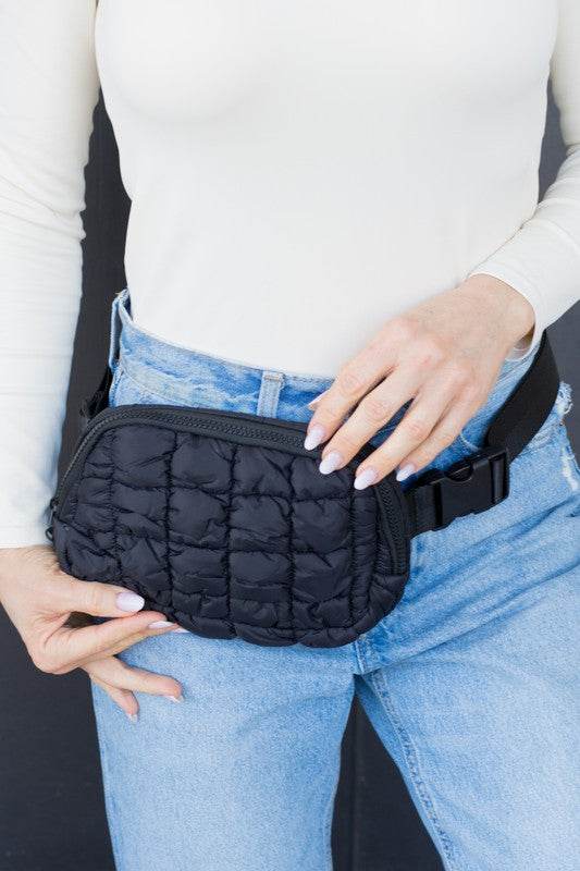 Babe Beachwear Lightweight Puffer Sling Bag in black worn over jeans with adjustable strap