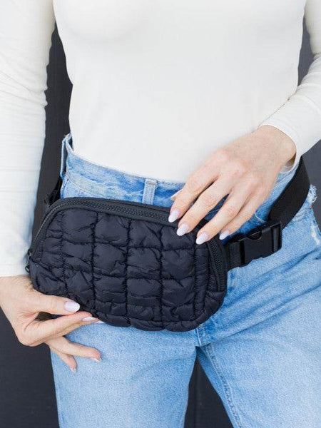 Babe Beachwear Lightweight Puffer Sling Bag in black worn over jeans with adjustable strap