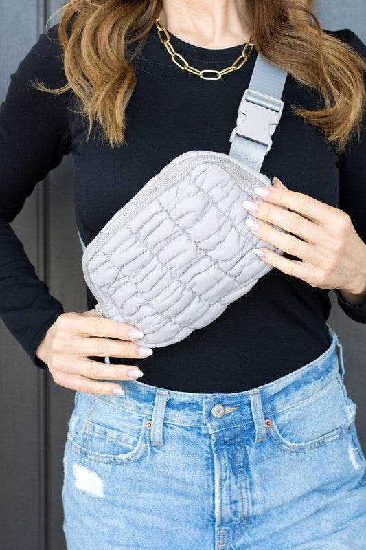 Babe Beachwaer Lightweight Puffer Sling Bag in light gray worn crossbody with adjustable strap