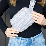 Babe Beachwaer Lightweight Puffer Sling Bag in light gray worn crossbody with adjustable strap