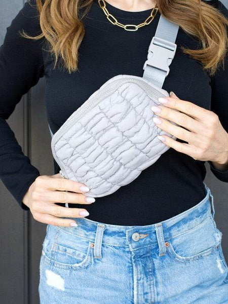 Babe Beachwaer Lightweight Puffer Sling Bag in light gray worn crossbody with adjustable strap