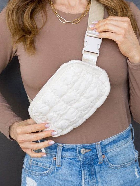 Babe Beachwear Lightweight Puffer Sling Bag in white worn with casual brown top and blue jeans
