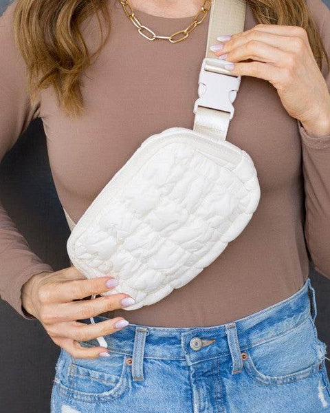 Babe Beachwear Lightweight Puffer Sling Bag in white worn with casual brown top and blue jeans