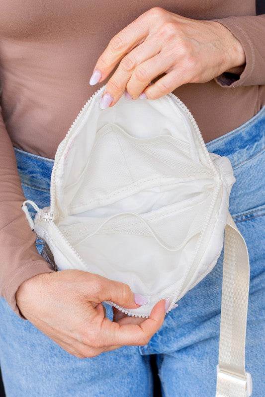 Inside view of Babe Beachwear Lightweight Puffer Sling Bag in white showing multiple compartments