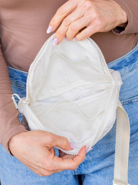 Inside view of Babe Beachwear Lightweight Puffer Sling Bag in white showing multiple compartments