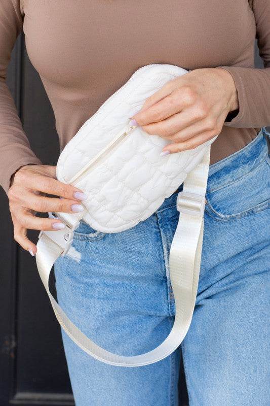 Babe Beachwear lightweight puffer sling bag in white worn with casual outfit
