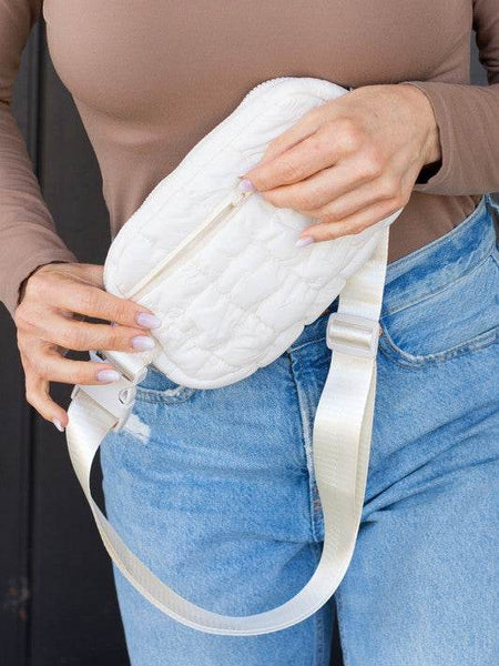 Babe Beachwear lightweight puffer sling bag in white worn with casual outfit