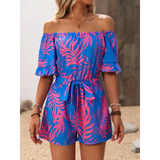 Babe Beachwaer off-shoulder beach romper with vibrant blue and pink tropical print and waist tie
