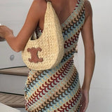 Babe Beachwear one shoulder mini dress with multicolor wave pattern and woman wearing a beige woven handbag