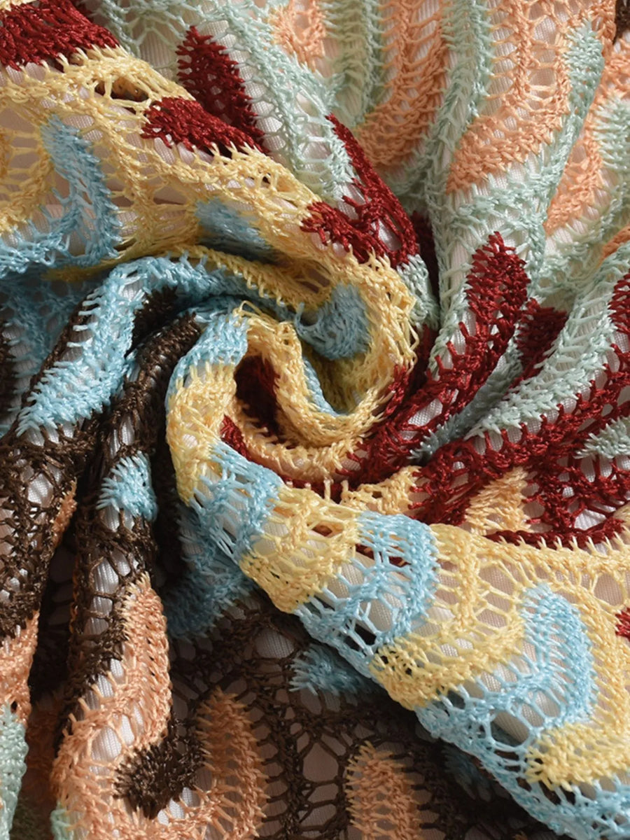 Close-up of multicolored crochet fabric for Babe Beachwear one shoulder mini dress