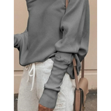 Gray one shoulder ribbed top for curvy women by Babe Beachwaer paired with white drawstring pants and a beige handbag