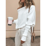 White one shoulder ribbed top for curvy women by Babe Beachwear styled with casual pants and a coffee cup