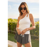 Trendsi white sleeveless one shoulder summer top worn with gray shorts outdoors