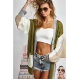 Trendsi oversized cardigan in green white and beige color block worn over white crop top and denim shorts