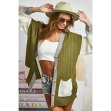 Trendsi oversized cardigan in olive green and white with button front and pockets worn with hat and sunglasses