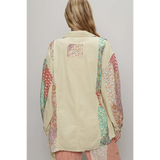 Back view of oversized printed button up shirt by Trendsi with colorful patterned sleeves and beige center