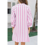 Back view of pink and white long sleeve vacation dress with vertical stripes on mini dress by Trendsi