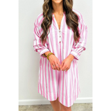 woman showing length of pink and white long sleeve vacation dress with vertical stripes and button detail