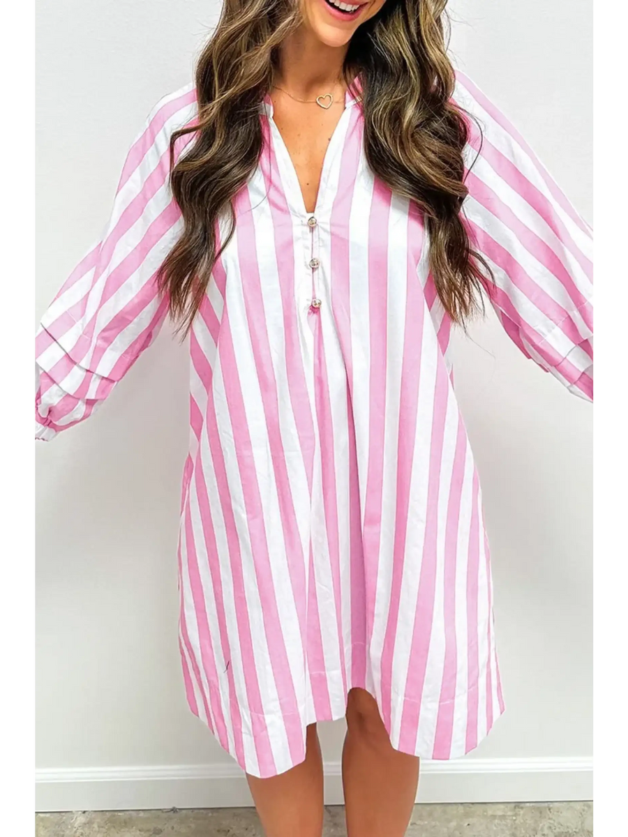 Woman showing long sleeve front pink and white long sleeve vacation dress with vertical stripes and button detail