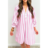 woman wearing a pink and white long sleeve vacation dress with vertical stripes and button detail
