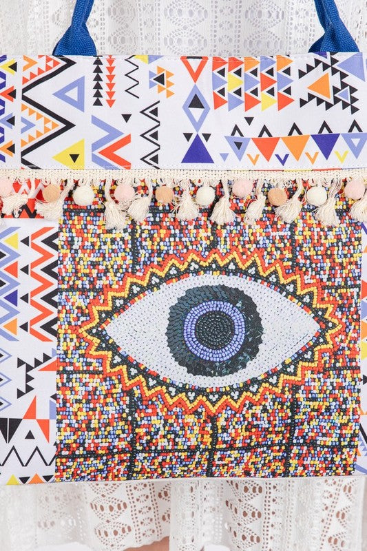 Babe Beachwaer Pom Pom Evil Eye bag with colorful geometric patterns and tassel details