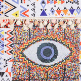 Babe Beachwaer Pom Pom Evil Eye bag with colorful geometric patterns and tassel details