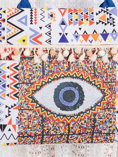 Babe Beachwaer Pom Pom Evil Eye bag with colorful geometric patterns and tassel details