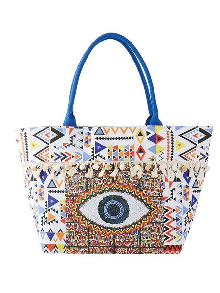 Babe Beachwear Pom Pom Evil Eye bag with colorful geometric patterns and blue handles