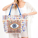 Pom Pom Evil Eye bag by Babe Beachwaer with colorful geometric patterns and blue handles