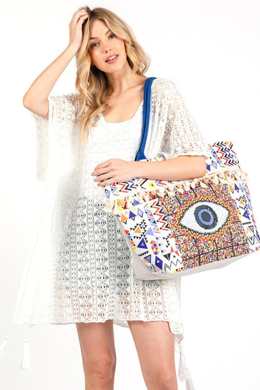 Pom Pom Evil Eye bag by Babe Beachwear with colorful geometric patterns and blue strap