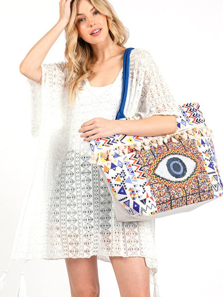 Pom Pom Evil Eye bag by Babe Beachwear with colorful geometric patterns and blue strap