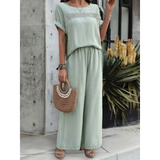 Light green satin pants set featuring wide-leg pants and a loose top with decorative detailing