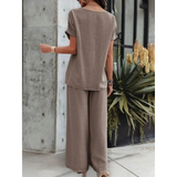 Back view of a woman wearing taupe satin Pants Set with short sleeves and wide-leg pants from Babe Beachwear