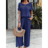 Babe Beachwear navy satin Pants Set with short sleeves and wide-leg pants styled with woven handbag