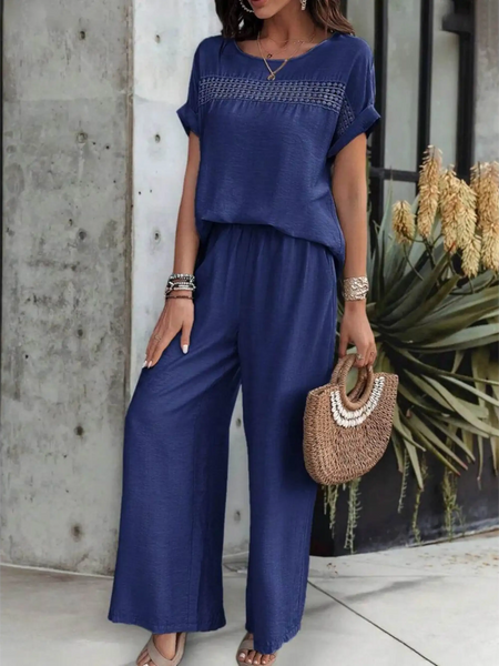 Babe Beachwear navy blue satin Pants Set with short sleeve top and wide leg pants styled with a woven handbag