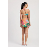 Back view of woman wearing Emory Park Tangerine Bikini Bralette with colorful tropical print skirt