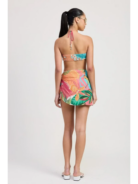 Back view of woman wearing Emory Park Tangerine Bikini Bralette with colorful tropical print skirt