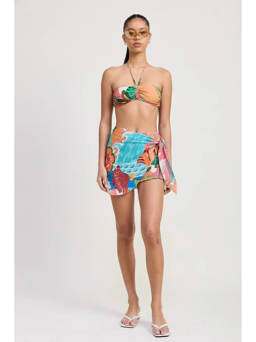 Emory Park Tangerine Bikini Bralette on model with tropical print sarong and white sandals
